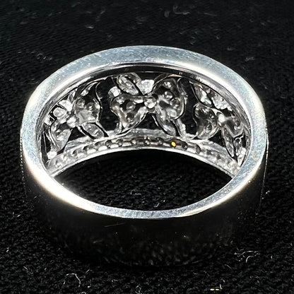 An art nouveau style 18k white gold ring set with round and marquise cut diamonds.