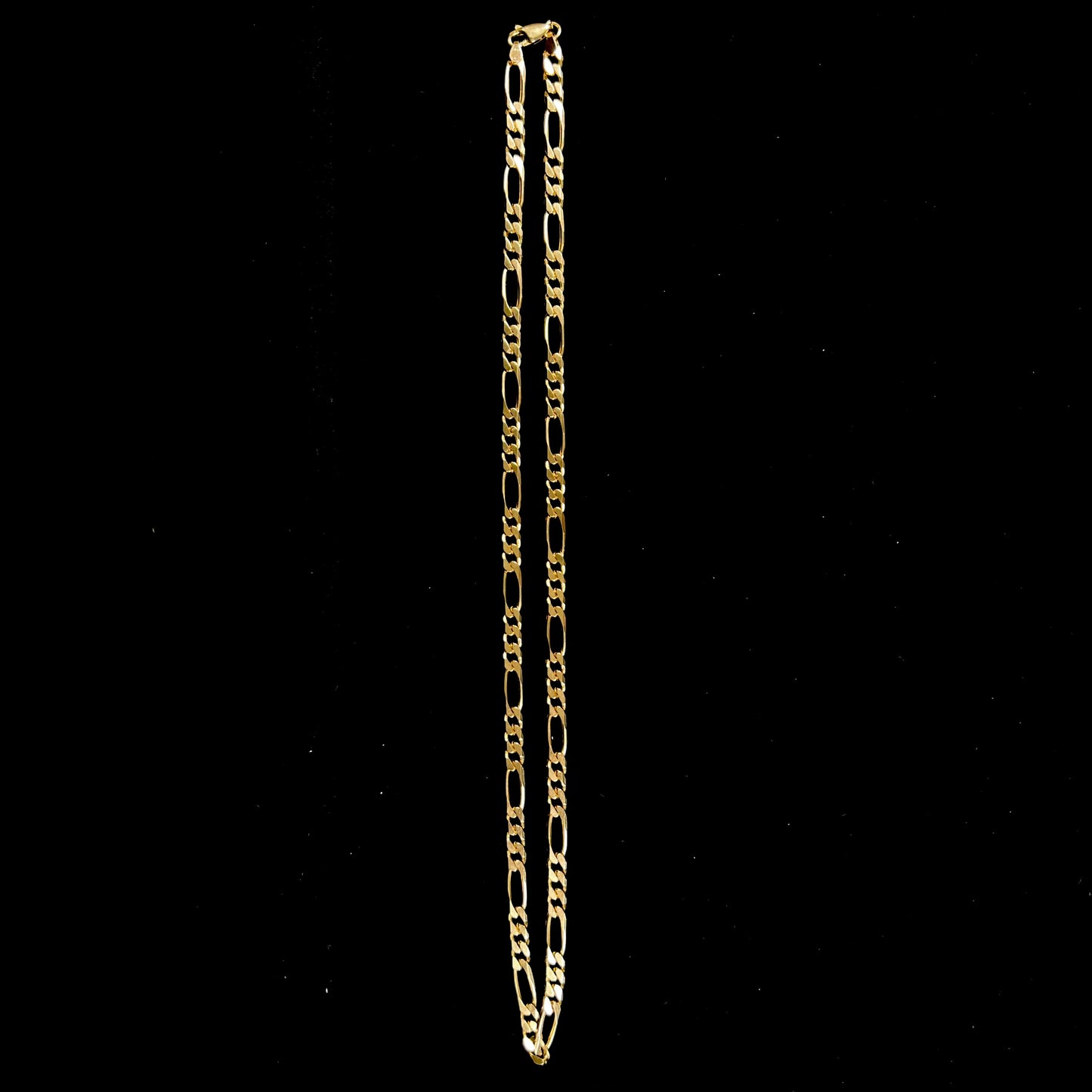 A 14k yellow gold men's figaro chain.