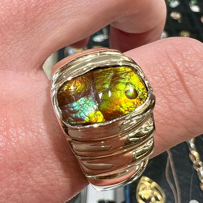 Men's fire agate solitaire ring cast in yellow gold.  The ring is a step design.