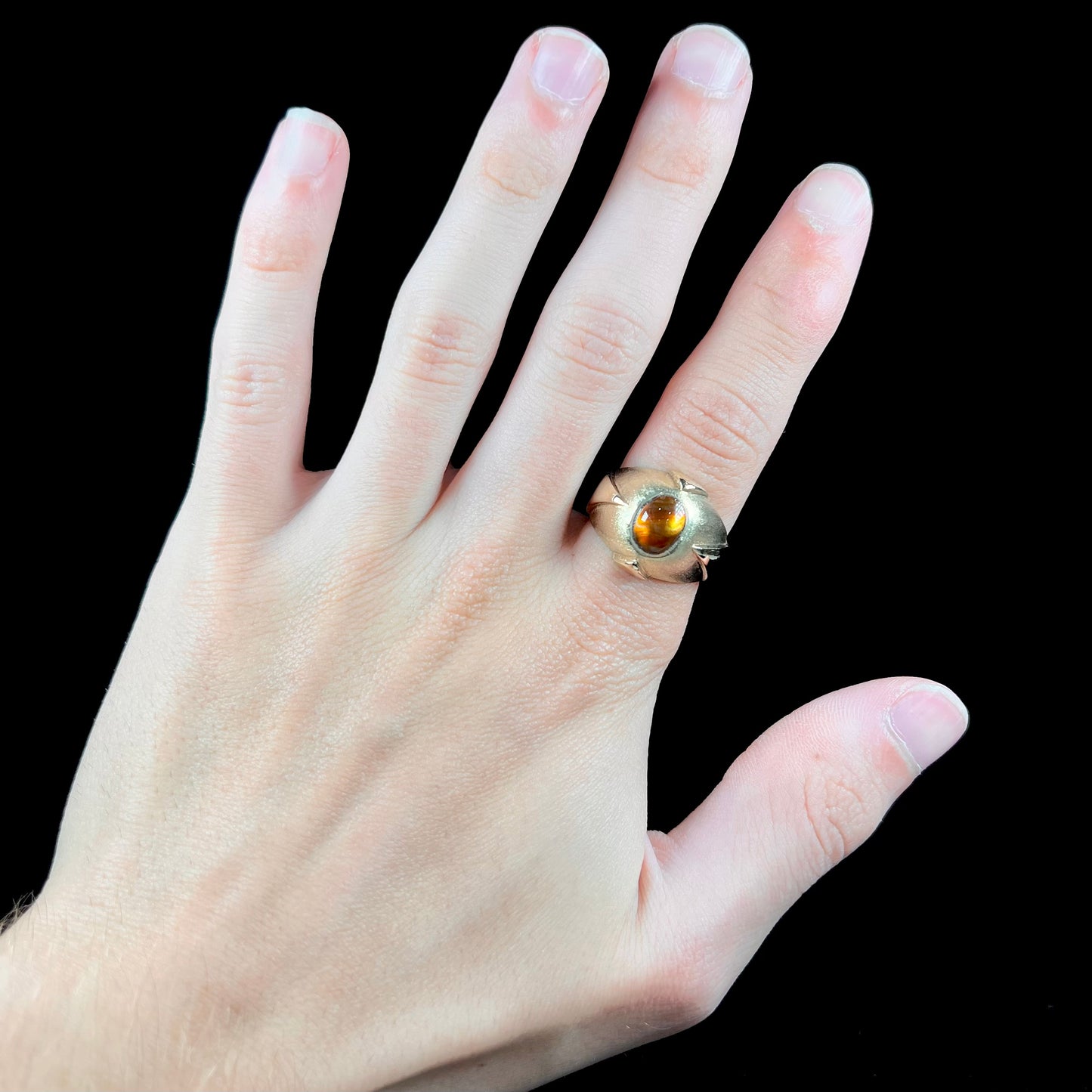 A men's brushed yellow gold fire agate ring with polished accents.