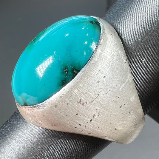 A men's textured silver turquoise solitaire ring.  The turquoise is from Royston Mining District, Nevada.