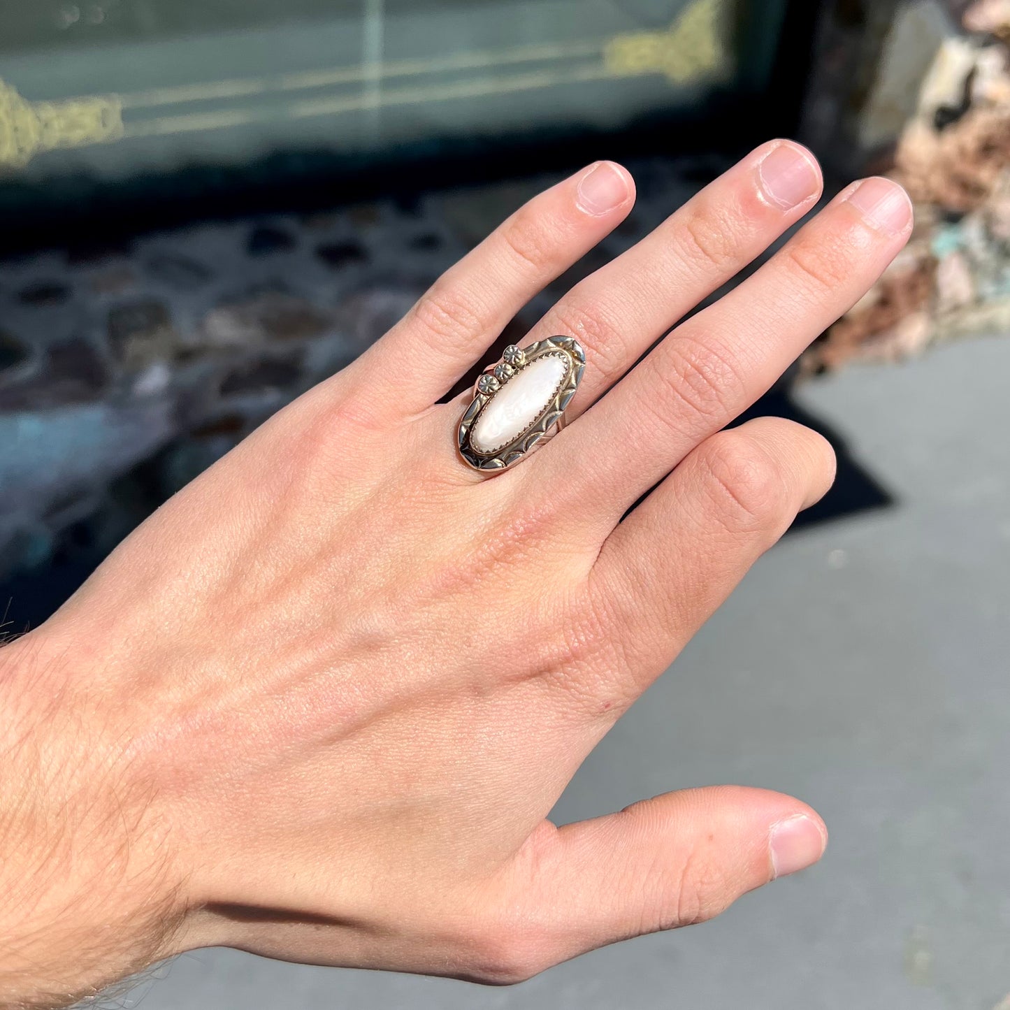 A Southwest style silver ring set with a faint pink mother of pearl stone.