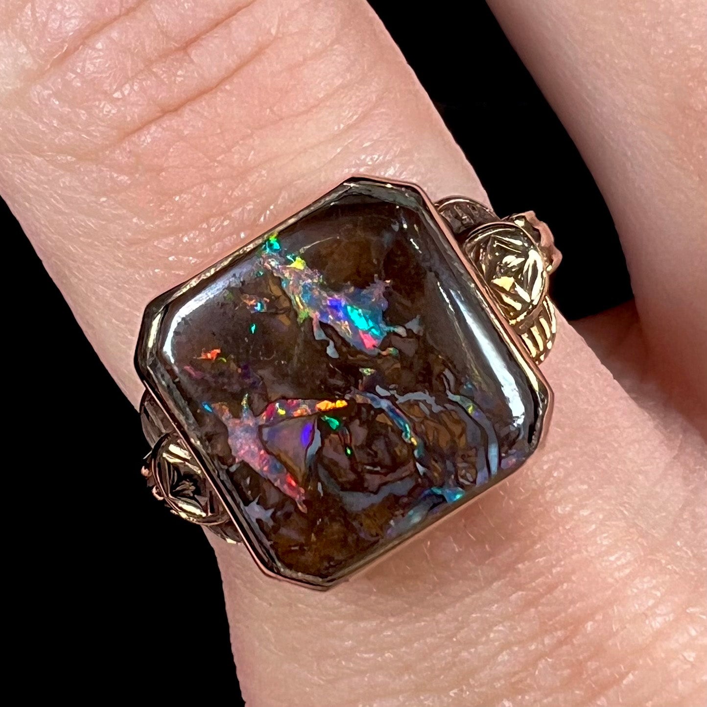 An antique yellow gold boulder opal ring.  The stone is a sqaure cut natural opal from Quilpie, Australia.