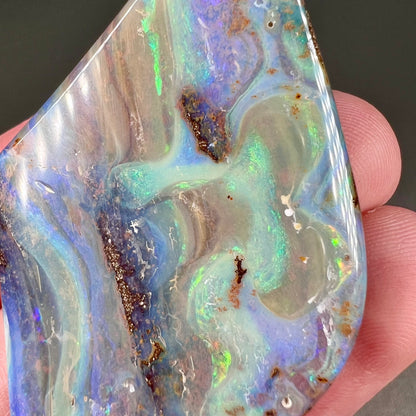 A polished boulder opal stone from Queensland, Australia.