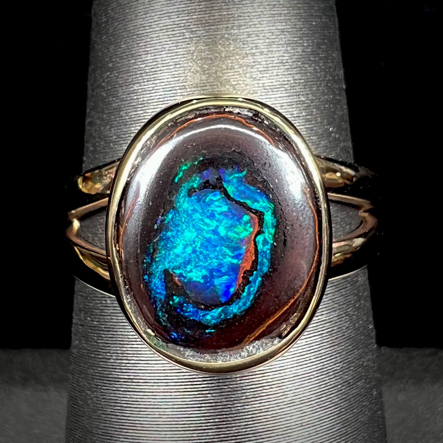 A natural Yowah Nut boulder opal split shank ring in 14kt yellow gold.