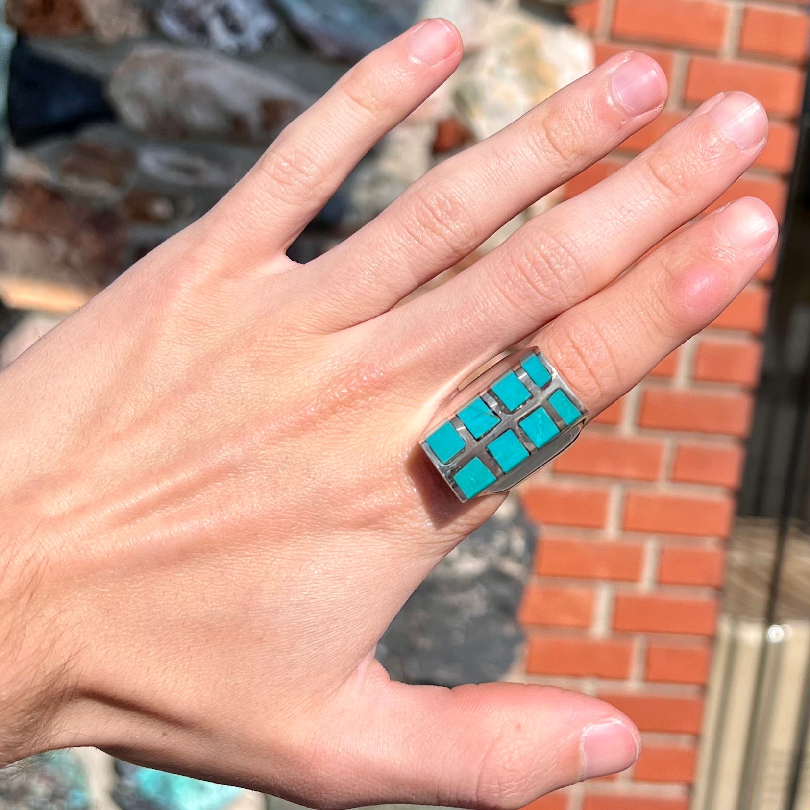 A men's sterling silver turquoise inlay ring, circa 1970.  The piece is set with 8 stones.