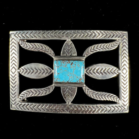 A handmade, Navajo style, sterling silver belt buckle set with a rectangular cabochon cut blue turquoise.