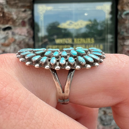 A petit point silver Zuni turquoise ring handmade by New Mexico artist Milburn Dishta.