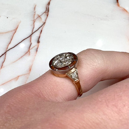 An antique yellow gold ring set with a cluster of old European cut diamonds.