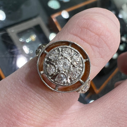 An antique yellow gold ring set with a cluster of old European cut diamonds.