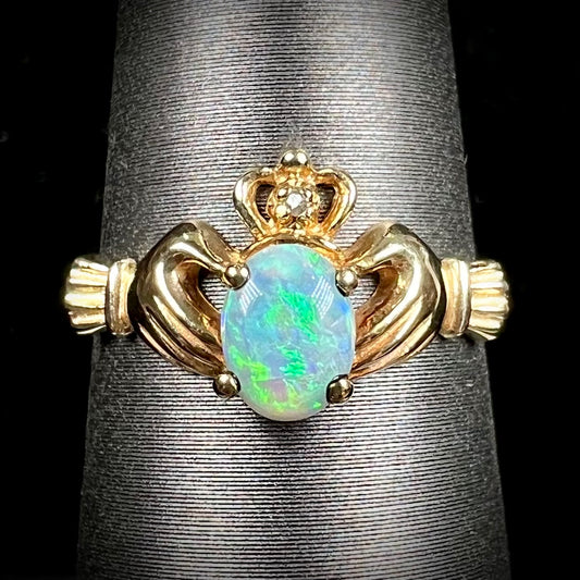 A vintage ladies' yellow gold opal and diamond claddagh ring.