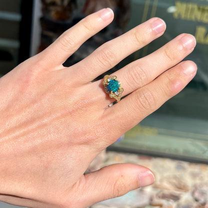 A ladies' 18kt yellow gold Lightning Ridge black opal and pave set diamond ring.