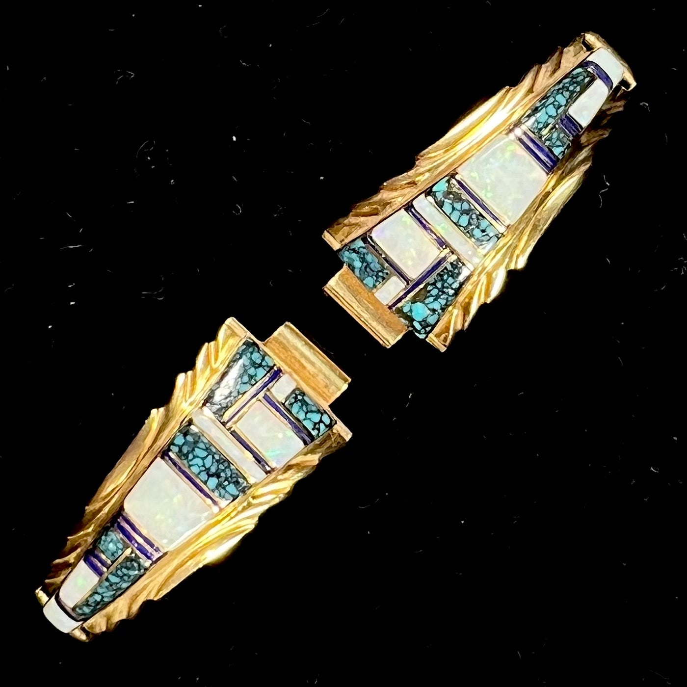 A pair of ladies' yellow gold watch cuffs inlaid with spiderweb turquoise and white crystal opal.