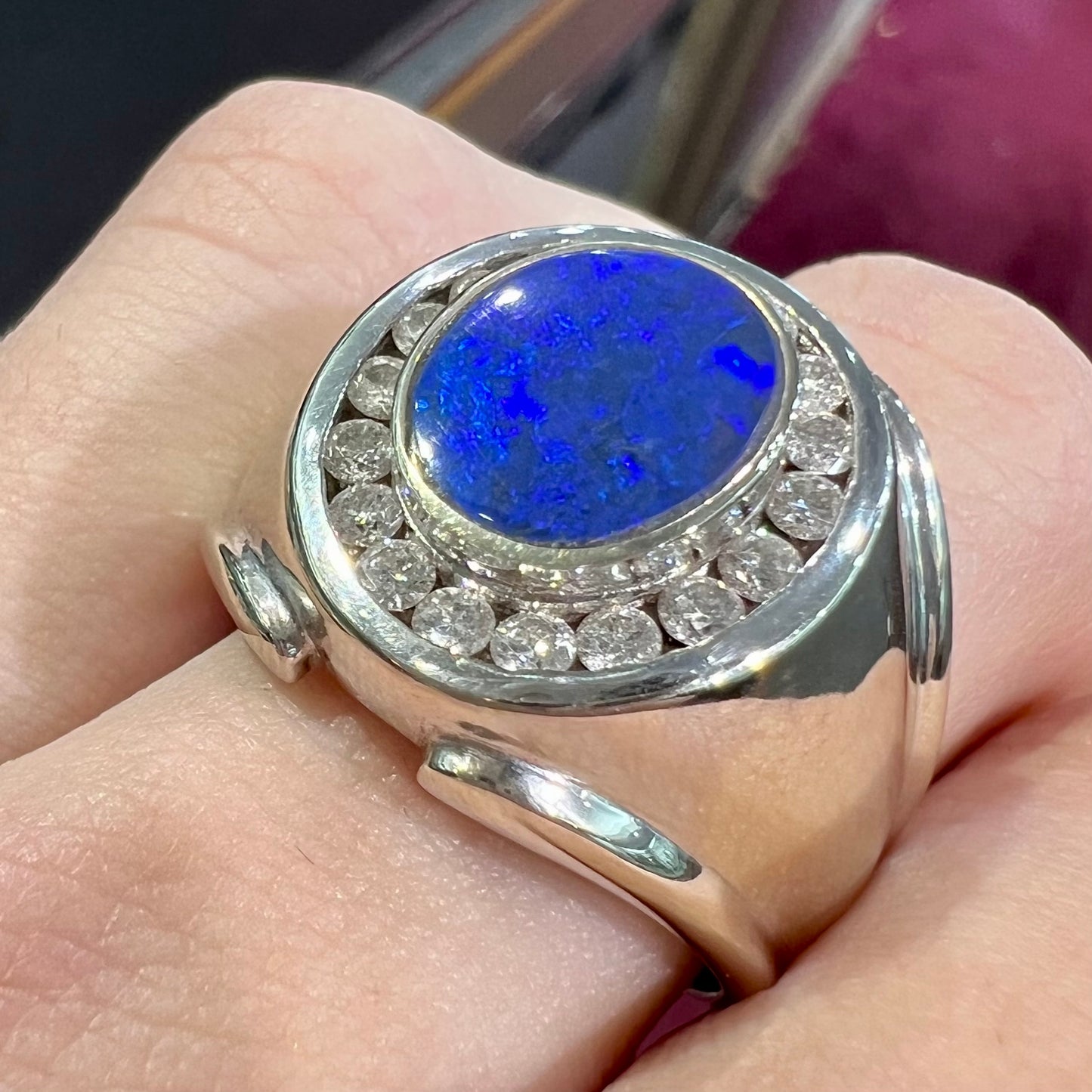 A men's black crystal opal and diamond halo ring in white gold.