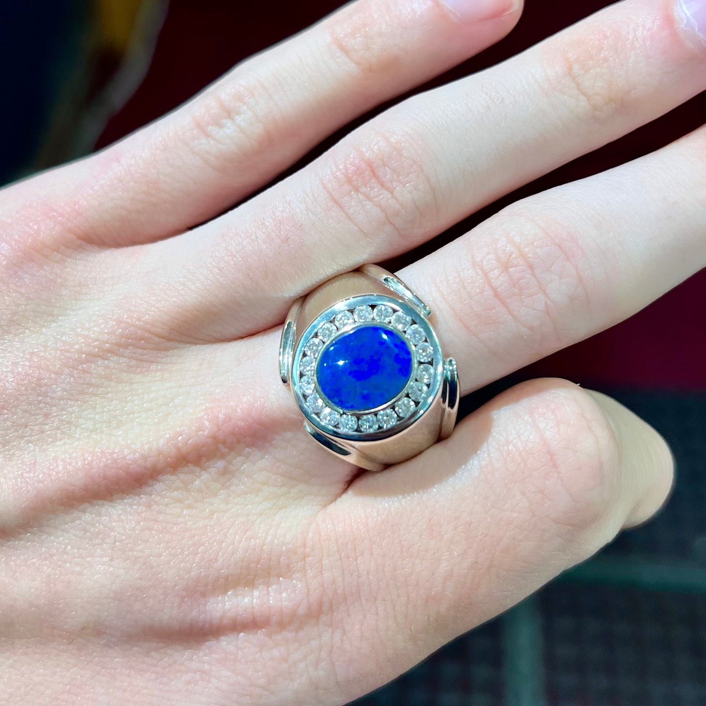 A men's black crystal opal and diamond halo ring in white gold.