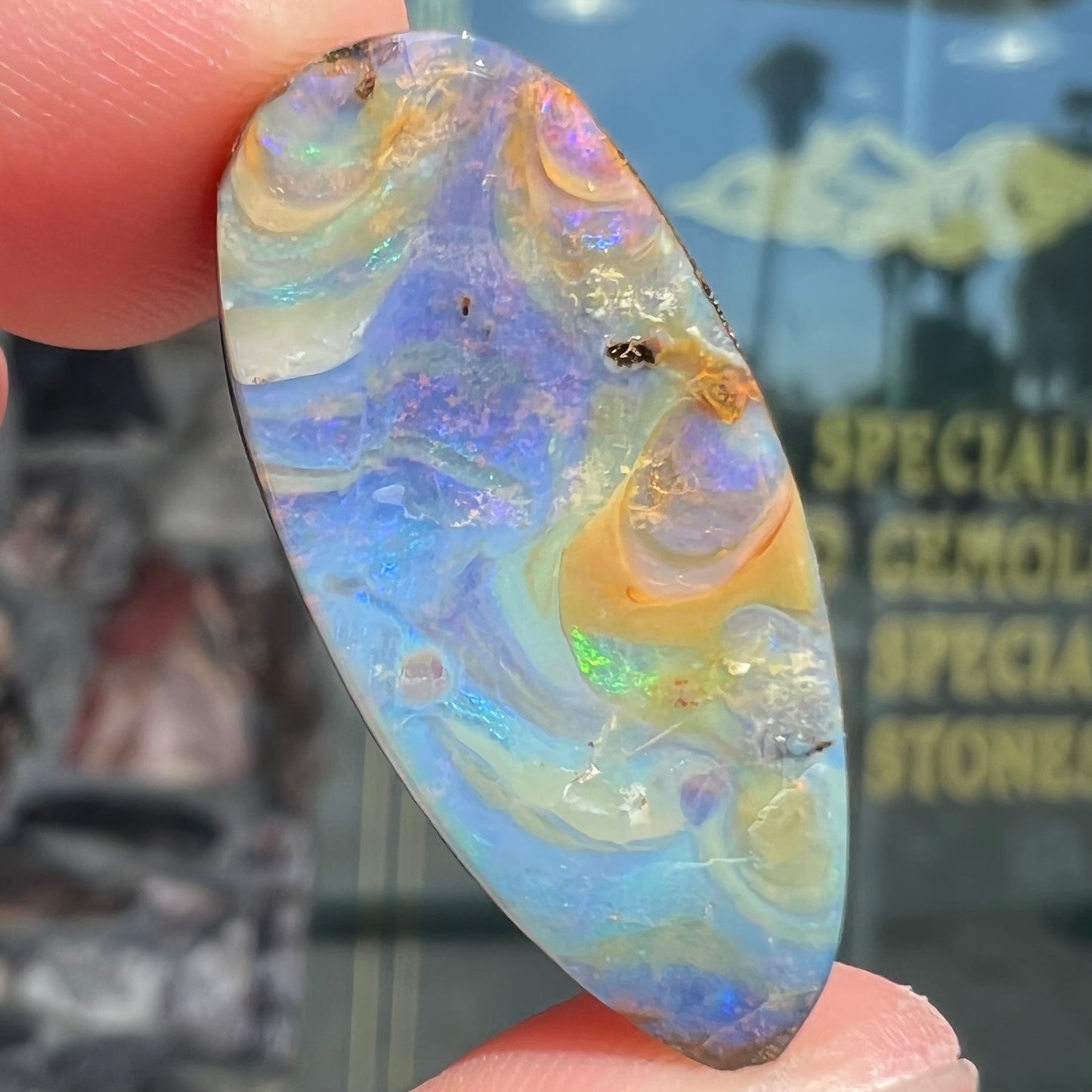 A loose, natural, pear shaped boulder opal stone from Quilpie, Australia.