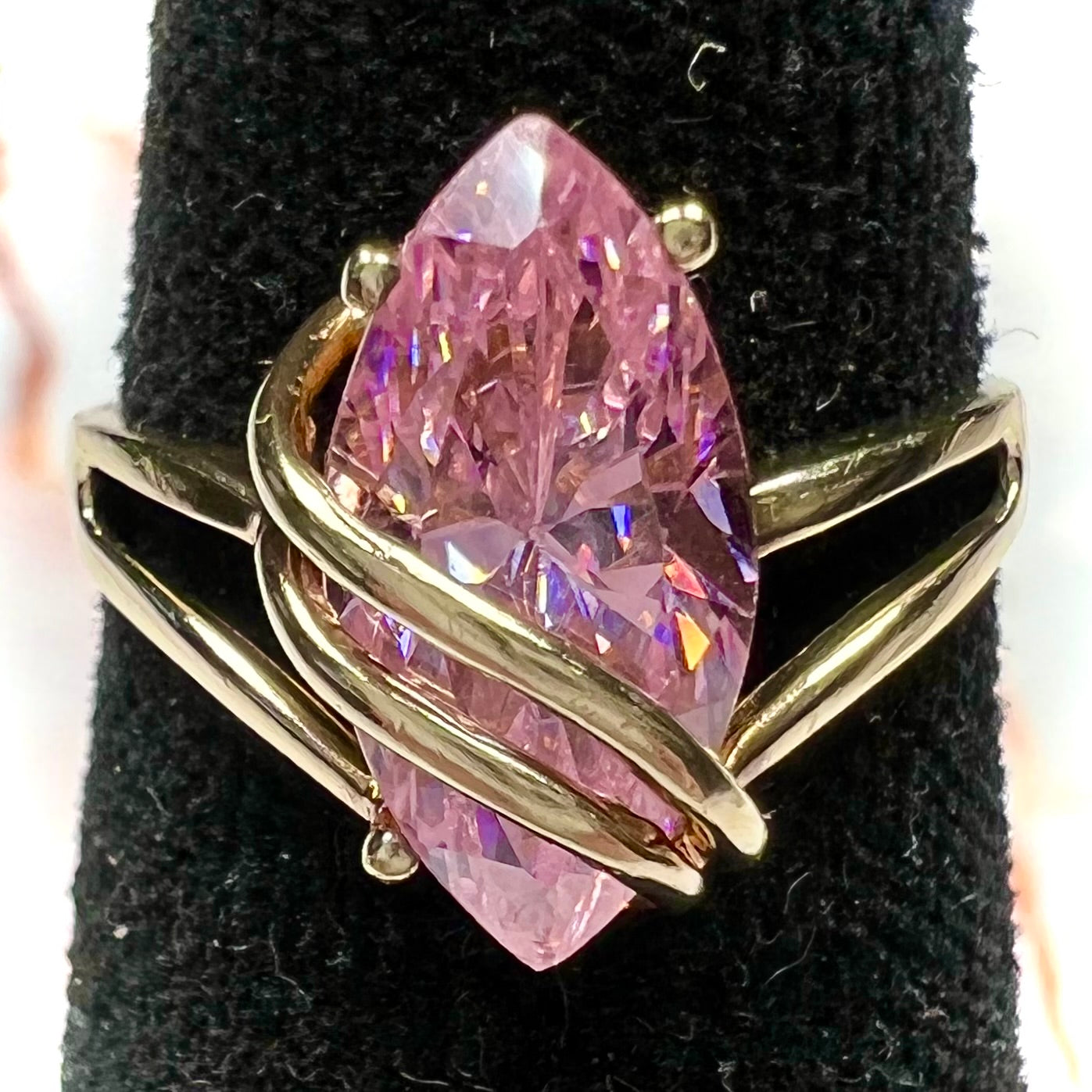 A yellow gold marquise cut pink cubic zirconia ring.