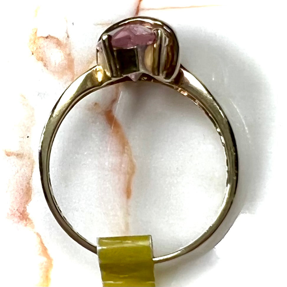 A yellow gold marquise cut pink cubic zirconia ring.