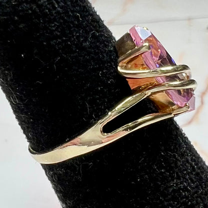 A yellow gold marquise cut pink cubic zirconia ring.