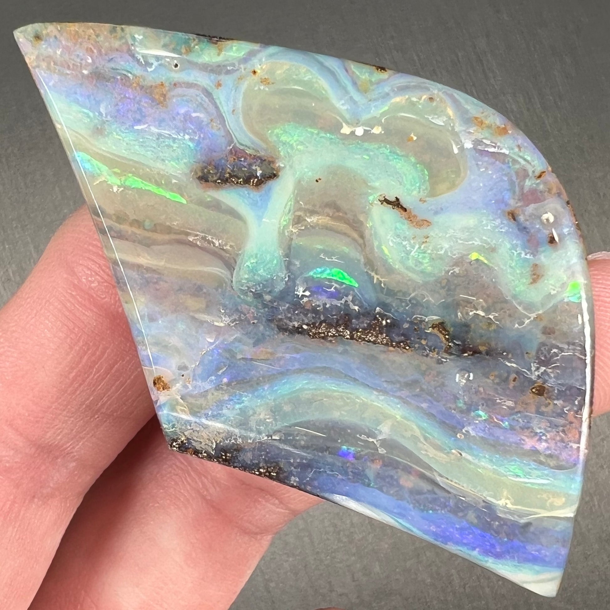 A polished boulder opal stone from Queensland, Australia.