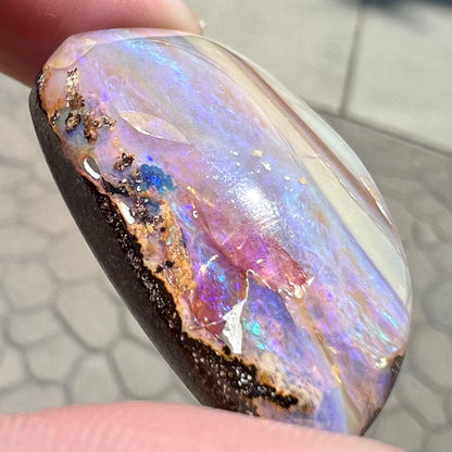 A loose, drop shaped Australian boulder opal from Quilpie Mining District.