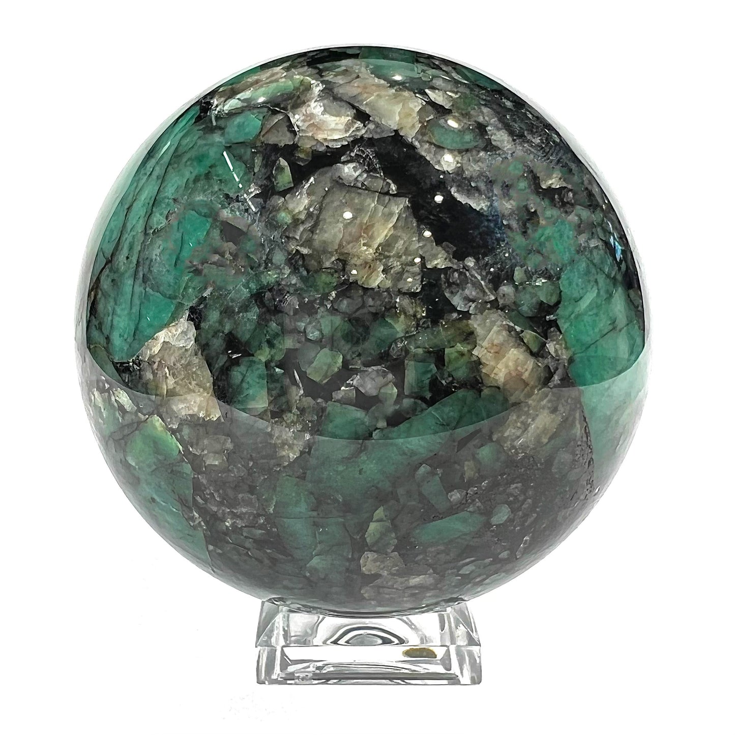 A gemstone sphere carved from a natural emerald crystal specimen, measuring 2.2 inches in diameter.