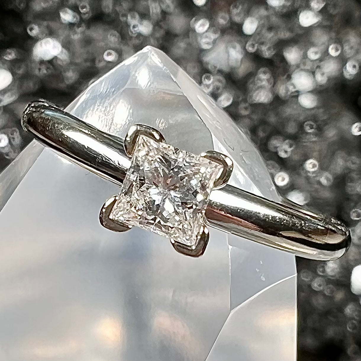 A quarter carat princess cut diamond solitaire engagement ring in white gold.