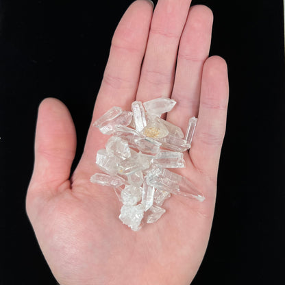 A lot of 26 small clear and white quartz crystals.