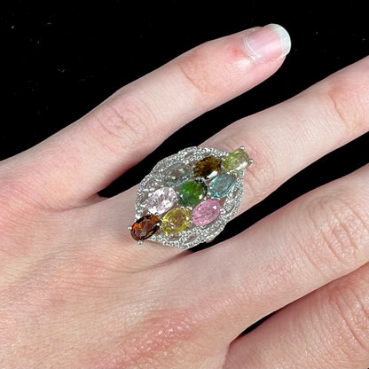 A silver gemstone cluster ring set with a rainbow of multicolored tourmaline stones.