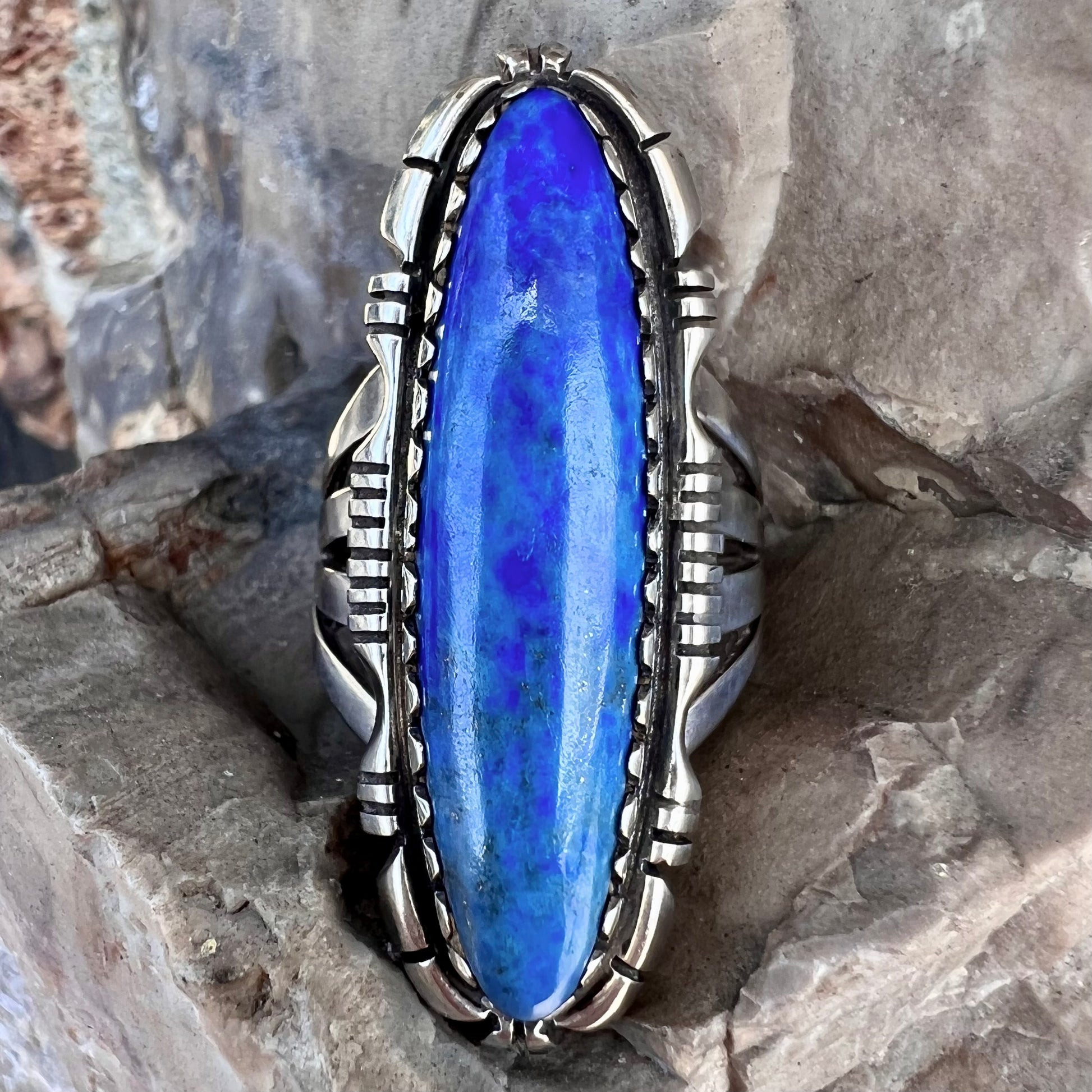 A Navajo style sterling silver lapis lazuli ring engraved with the words "R. Bennett".