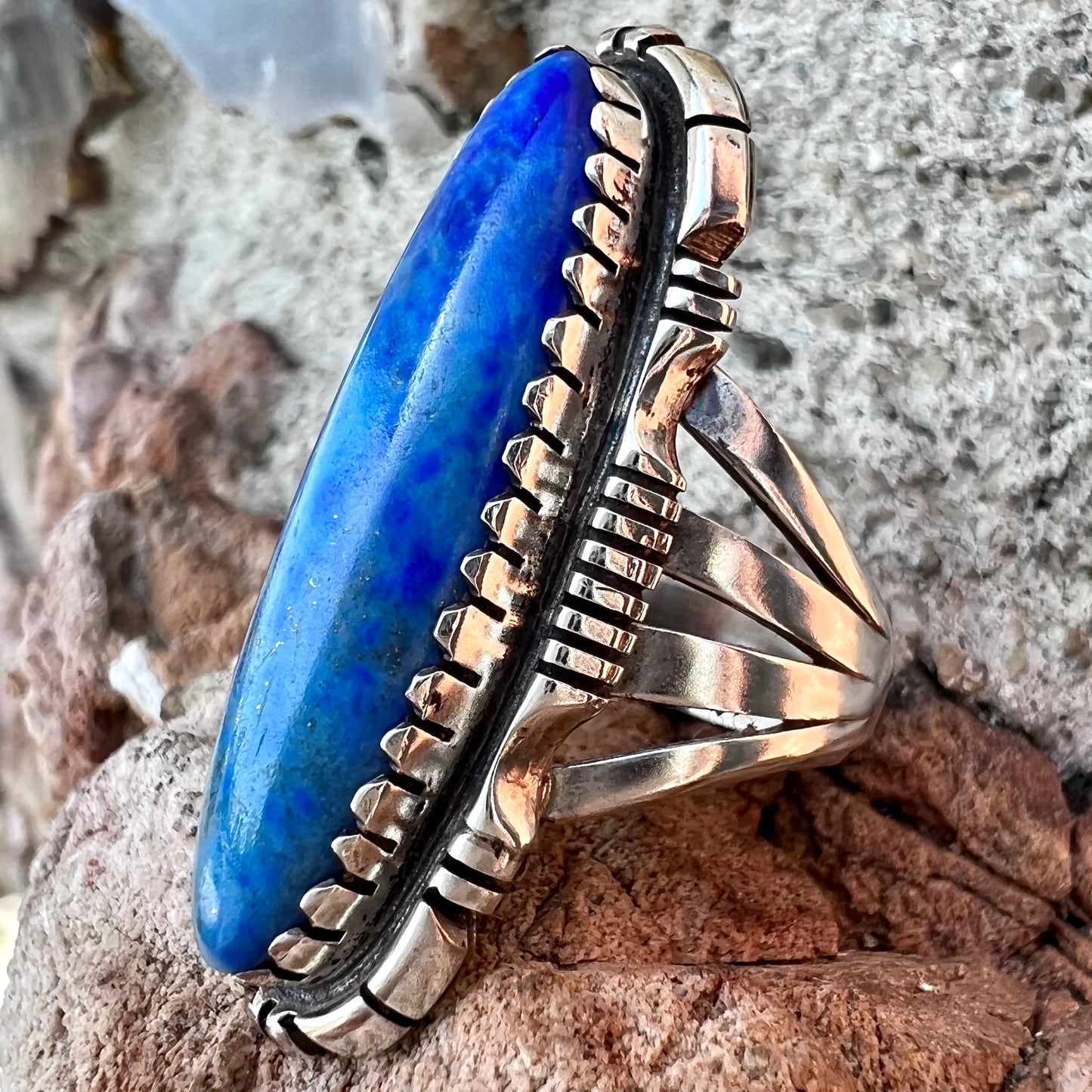 A Navajo style sterling silver lapis lazuli ring engraved with the words "R. Bennett".