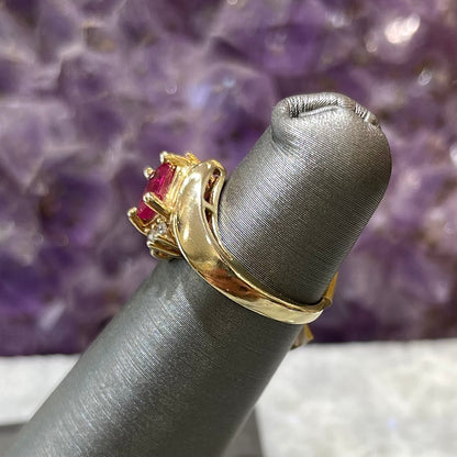 Emerald cut Burma ruby and diamond ring set in 14 karat yellow gold.