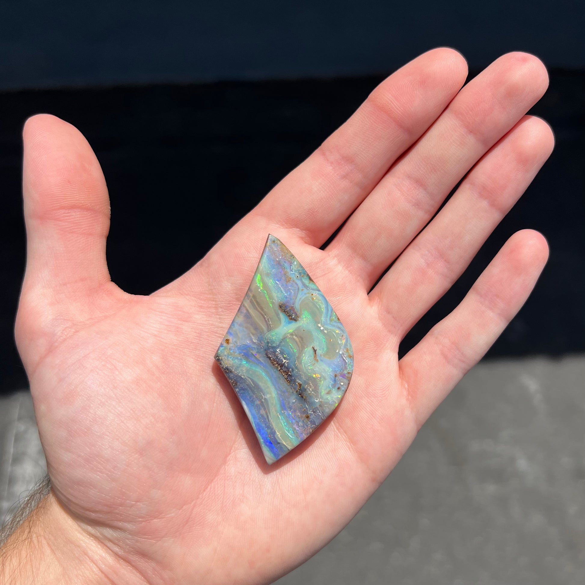 A polished boulder opal stone from Queensland, Australia.