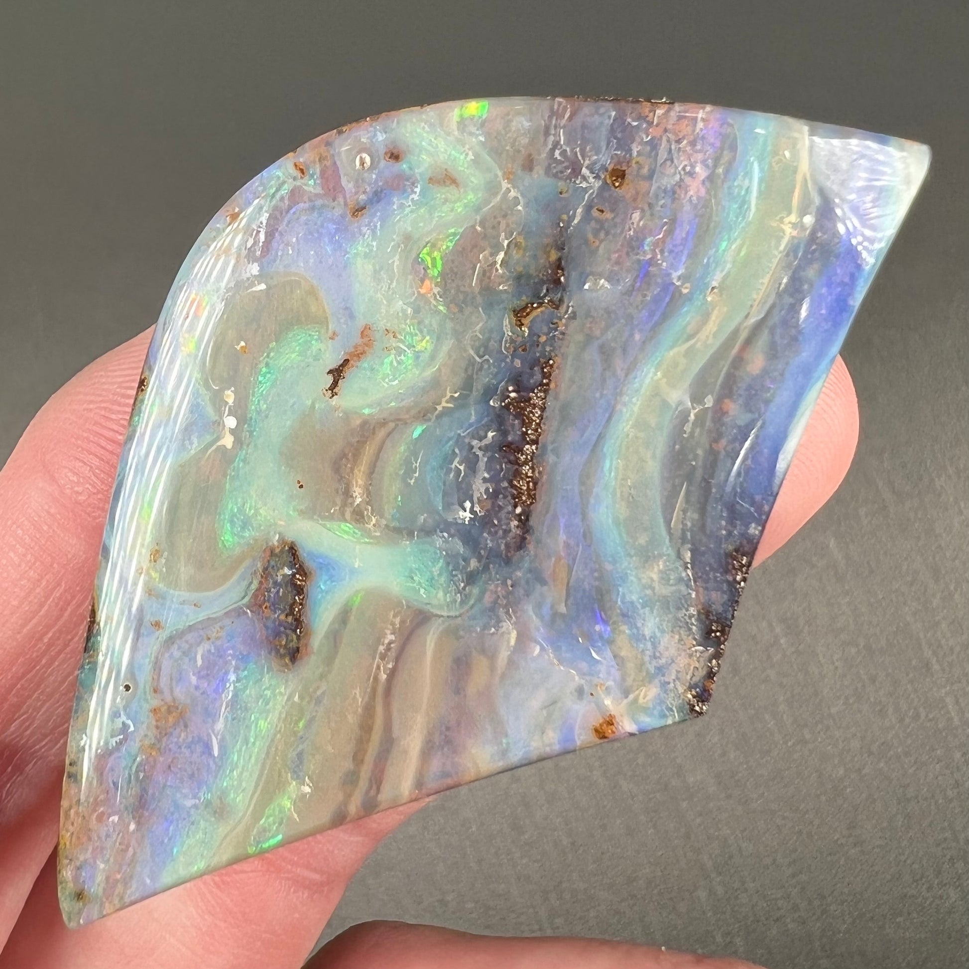 A polished boulder opal stone from Queensland, Australia.