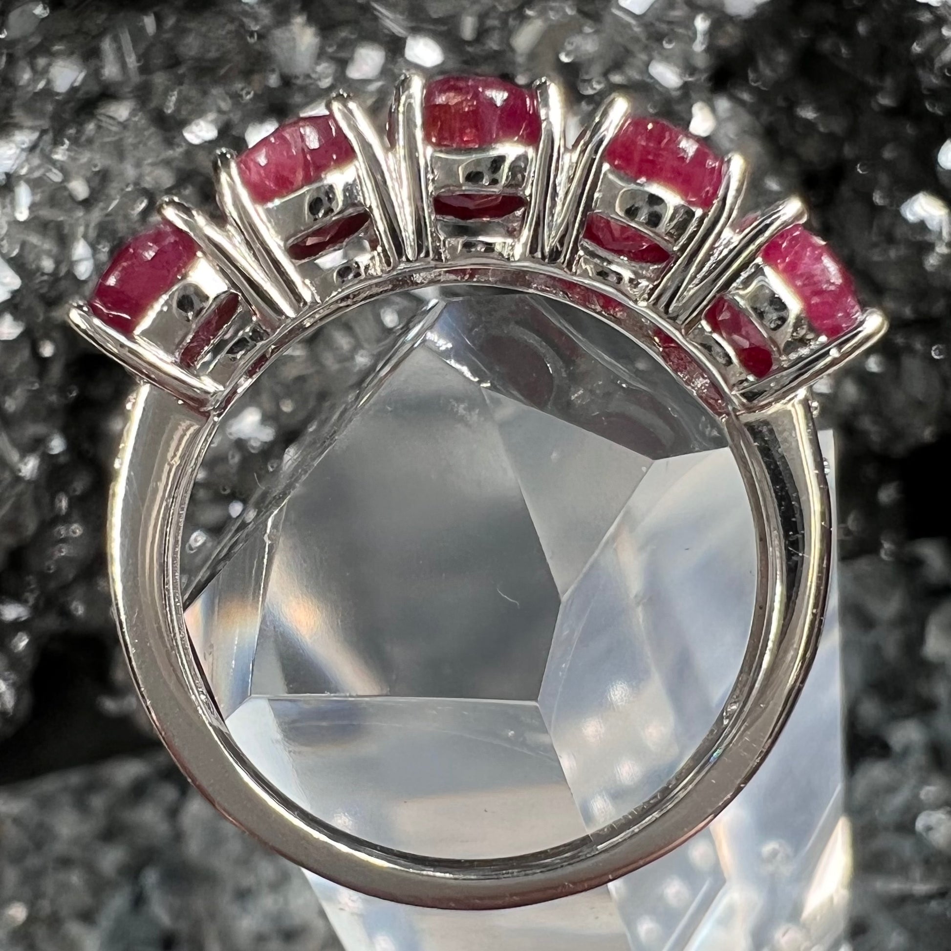 A sterling silver, five stone, faceted oval cut red ruby stackable ring.