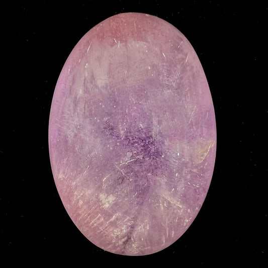 A cabochon cut red amethyst stone from Mexico.  The piece shows a faint star.