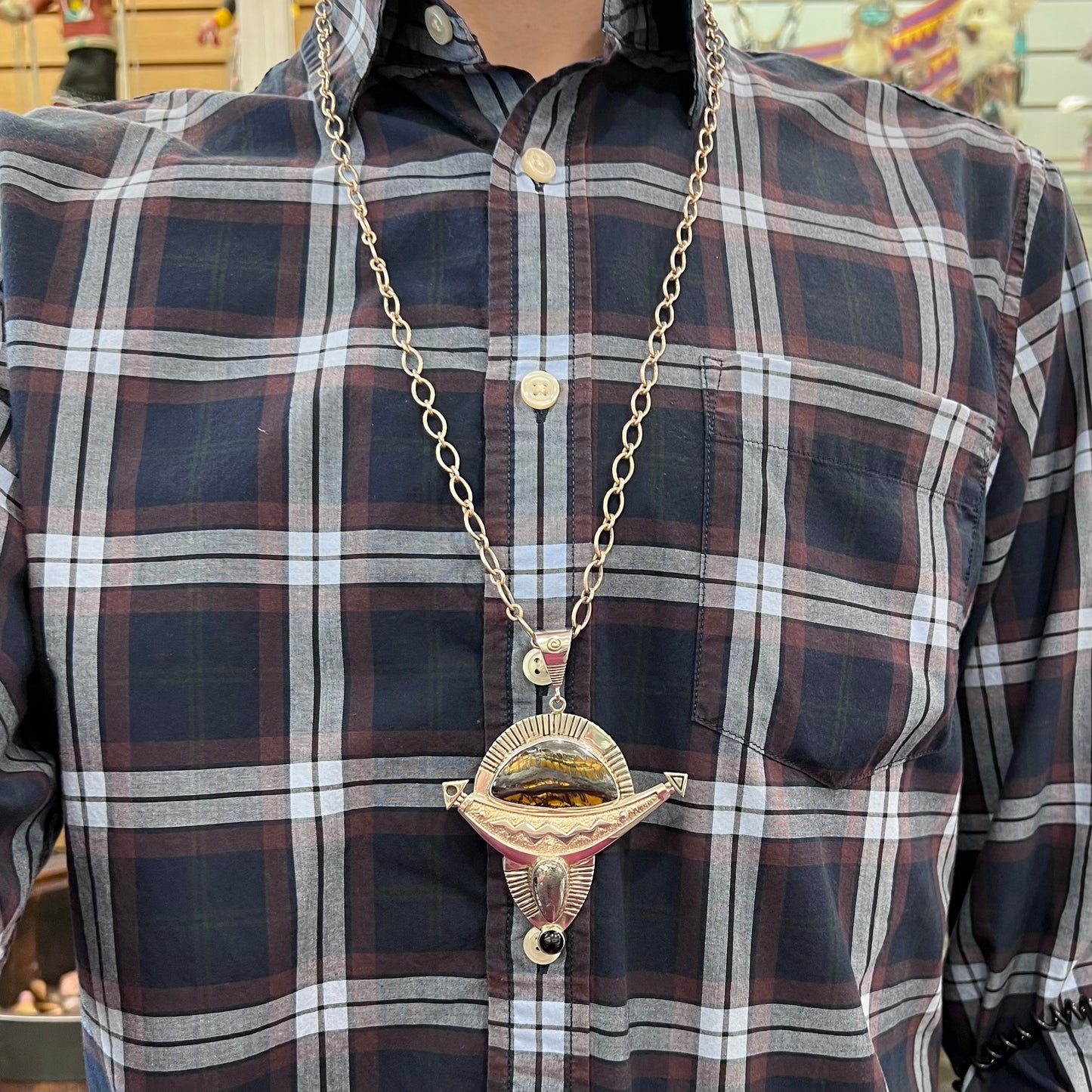 A Zuni style sterling silver necklace set with tiger iron, hematite, and black onyx stones.