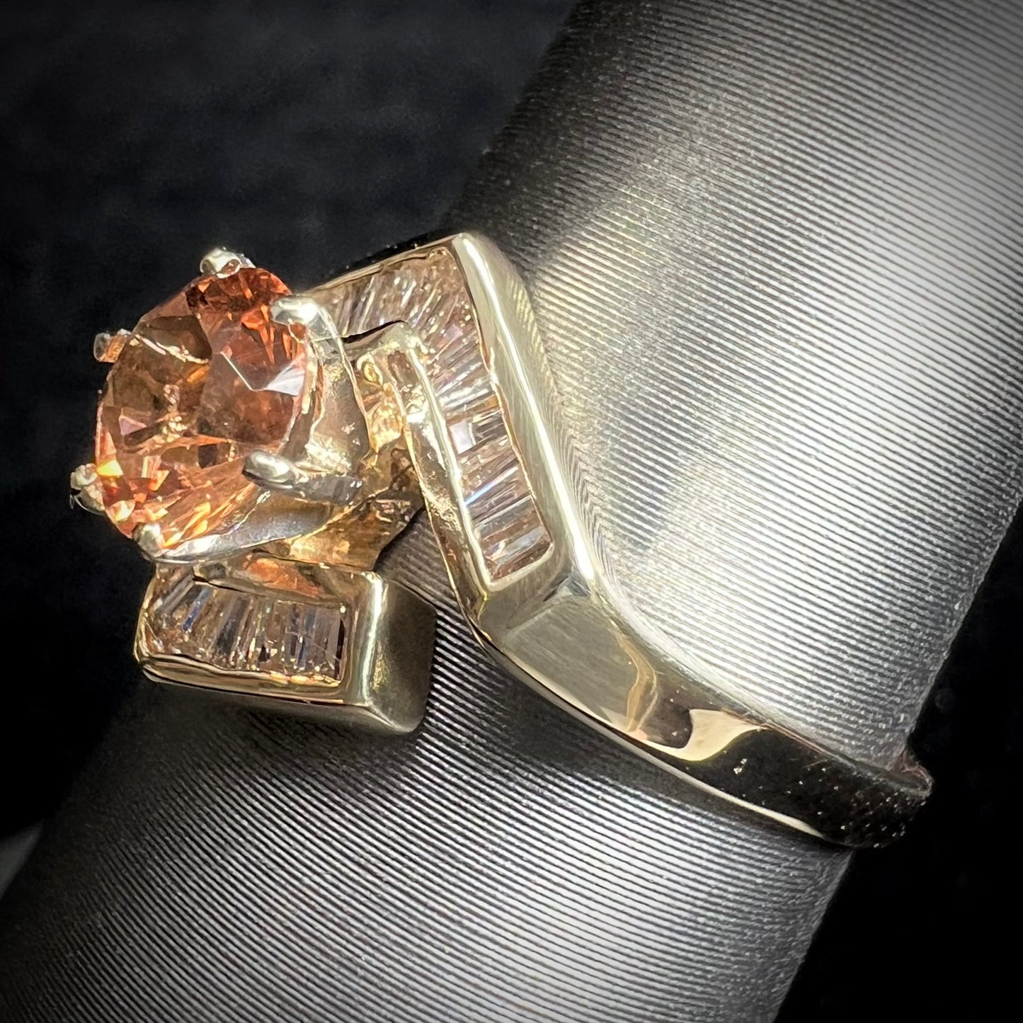 A yellow gold ladies' golden topaz ring set with baguette cut side diamonds.