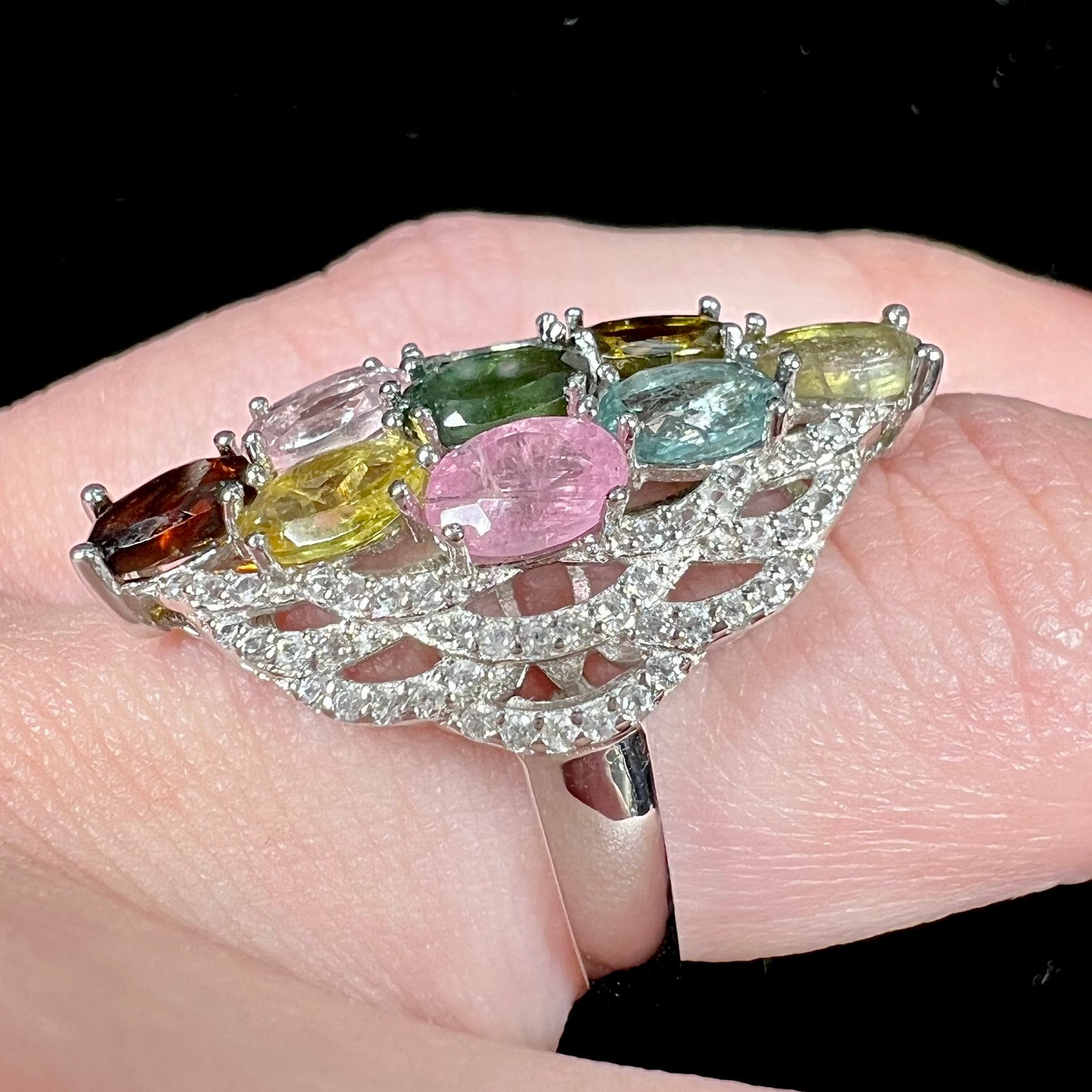 A silver gemstone cluster ring set with a rainbow of multicolored tourmaline stones.