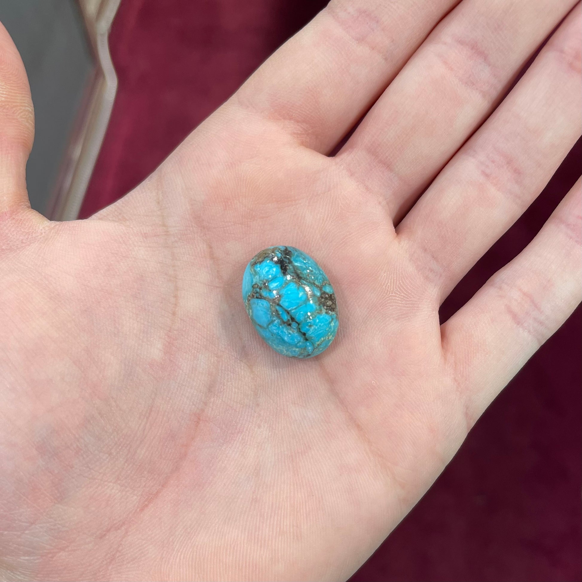 A loose, oval cabochon cut turquoise stone from the Valley Blue Mine in Lander County, Nevada.