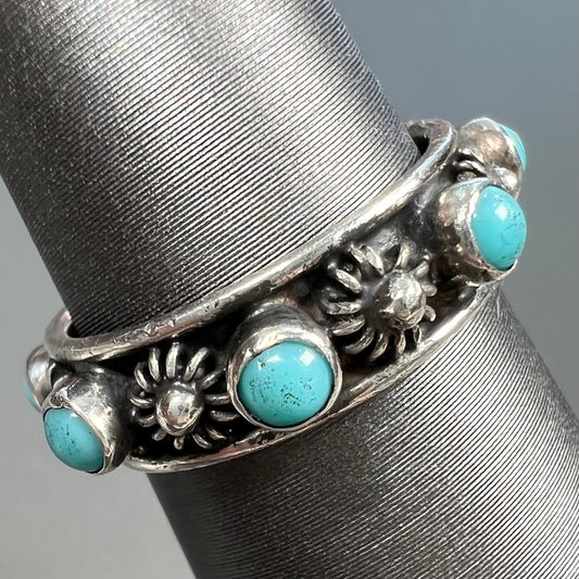 A sterling silver turquoise and flower design eternity band, made in Mexico.