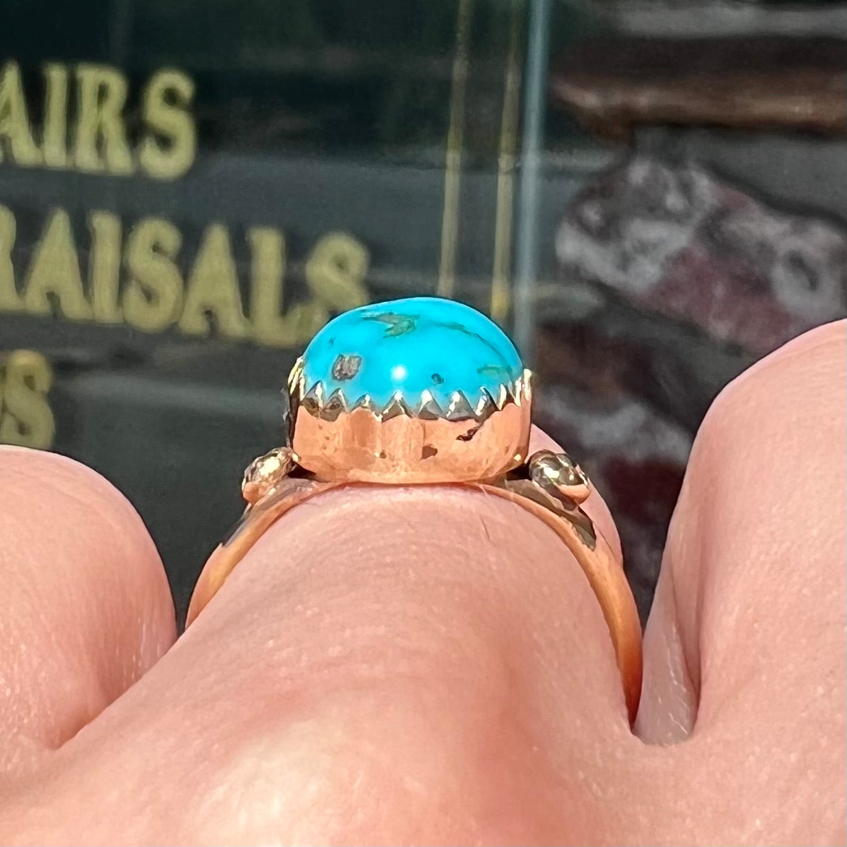 A ladies' yellow gold turquoise ring.  The turquoise is a round cabochon cut.