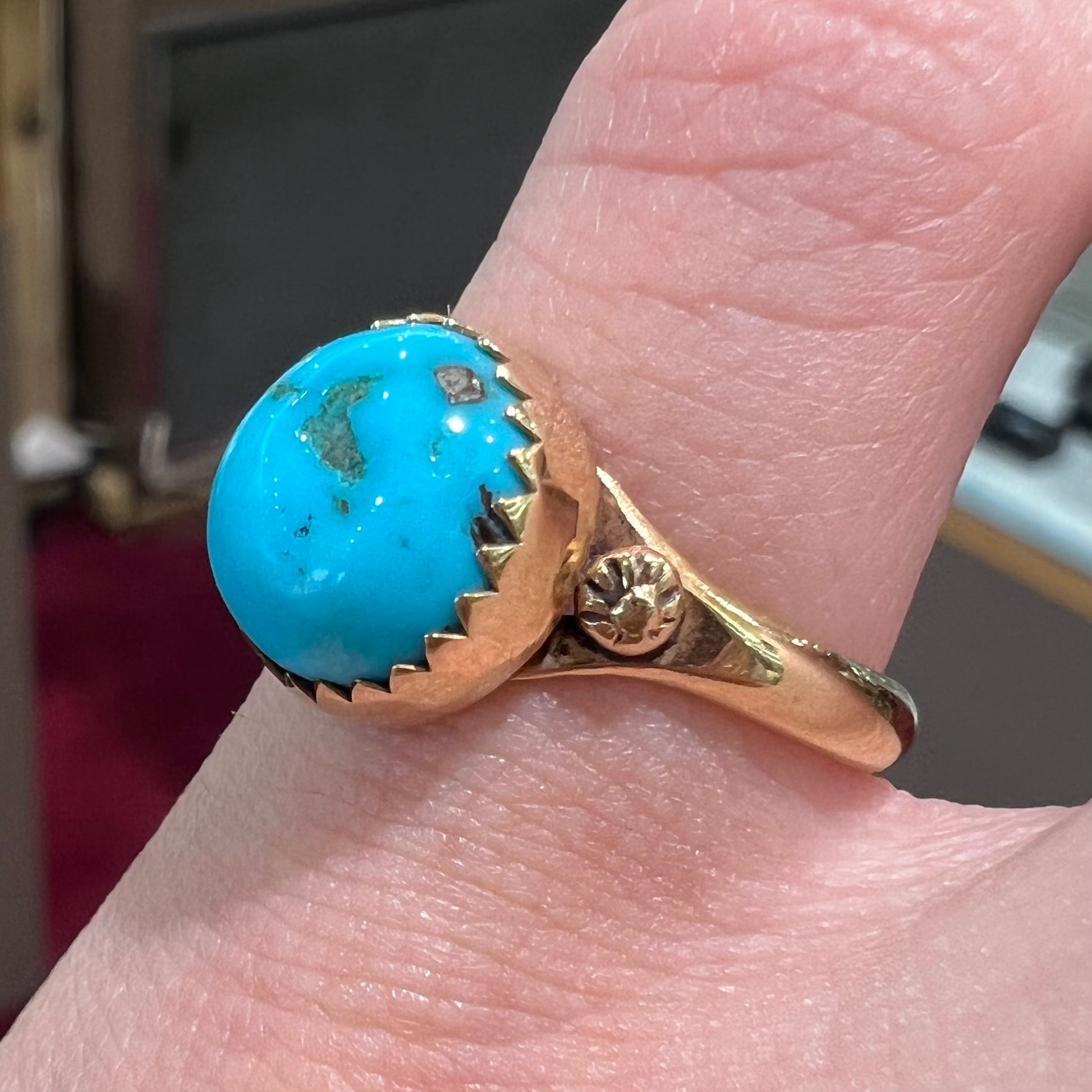 A ladies' yellow gold turquoise ring.  The turquoise is a round cabochon cut.