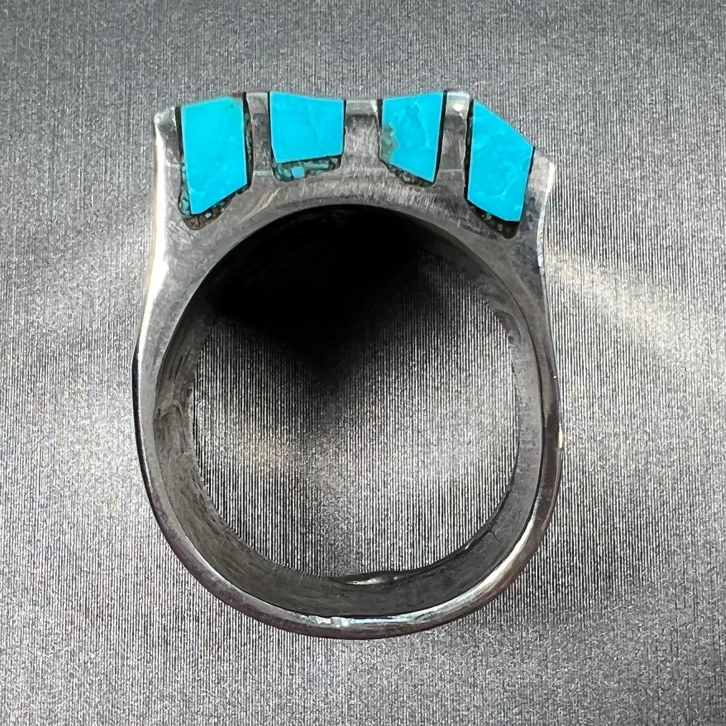 A men's turquoise ring inlay set with four turquoise stones.