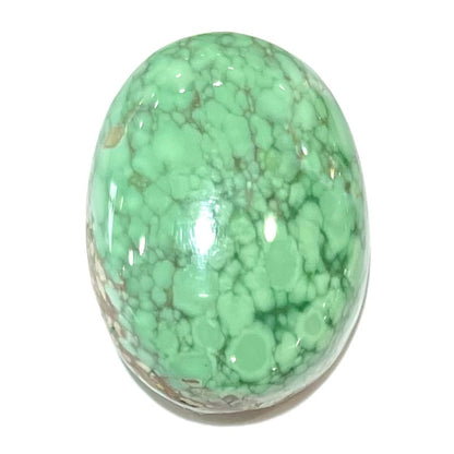 An oval cabochon cut green Variscite stone from Utah, USA.