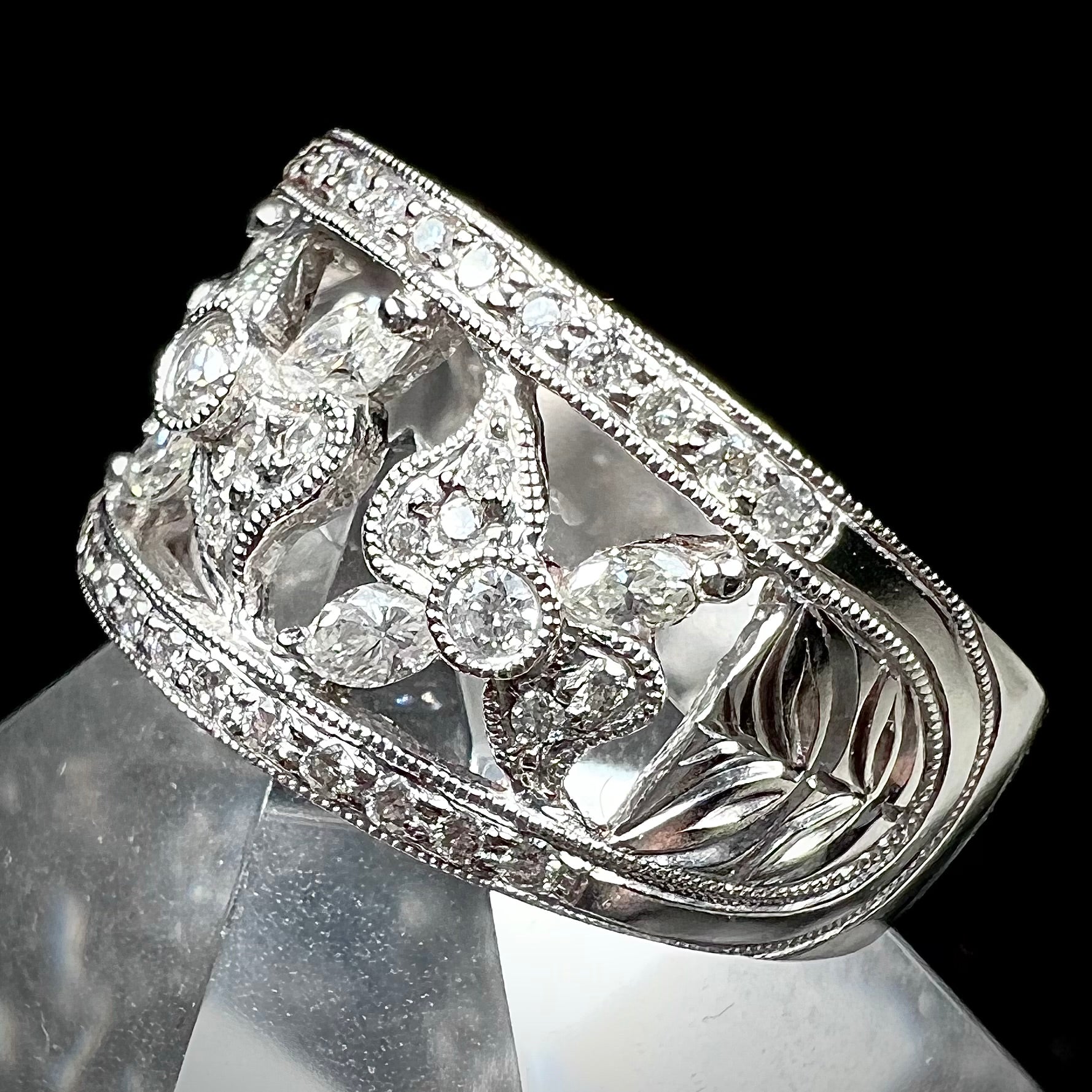 An art nouveau style 18k white gold ring set with round and marquise cut diamonds.