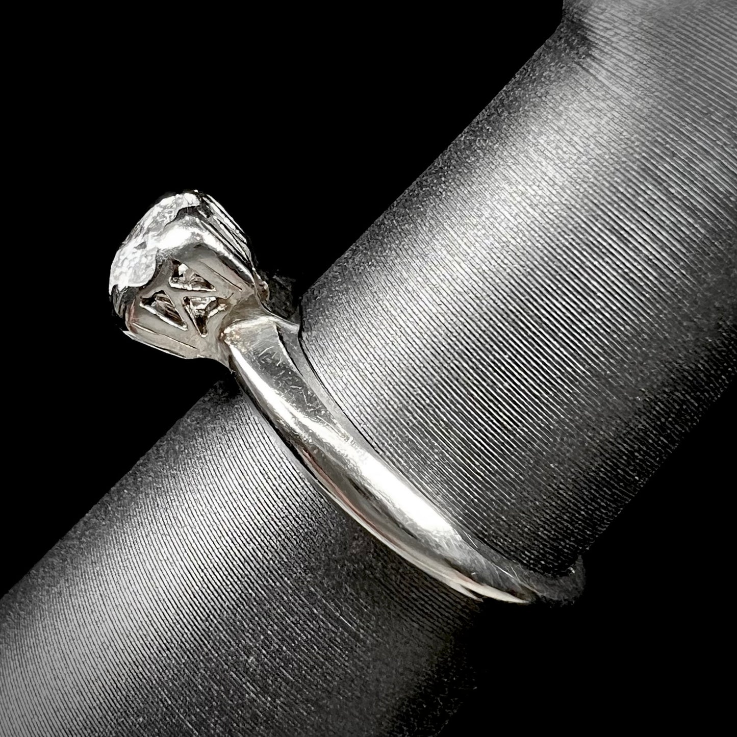 A ladies' vintage 14kt white gold 1940's diamond solitaire ring.  The diamond is chipped in two places.