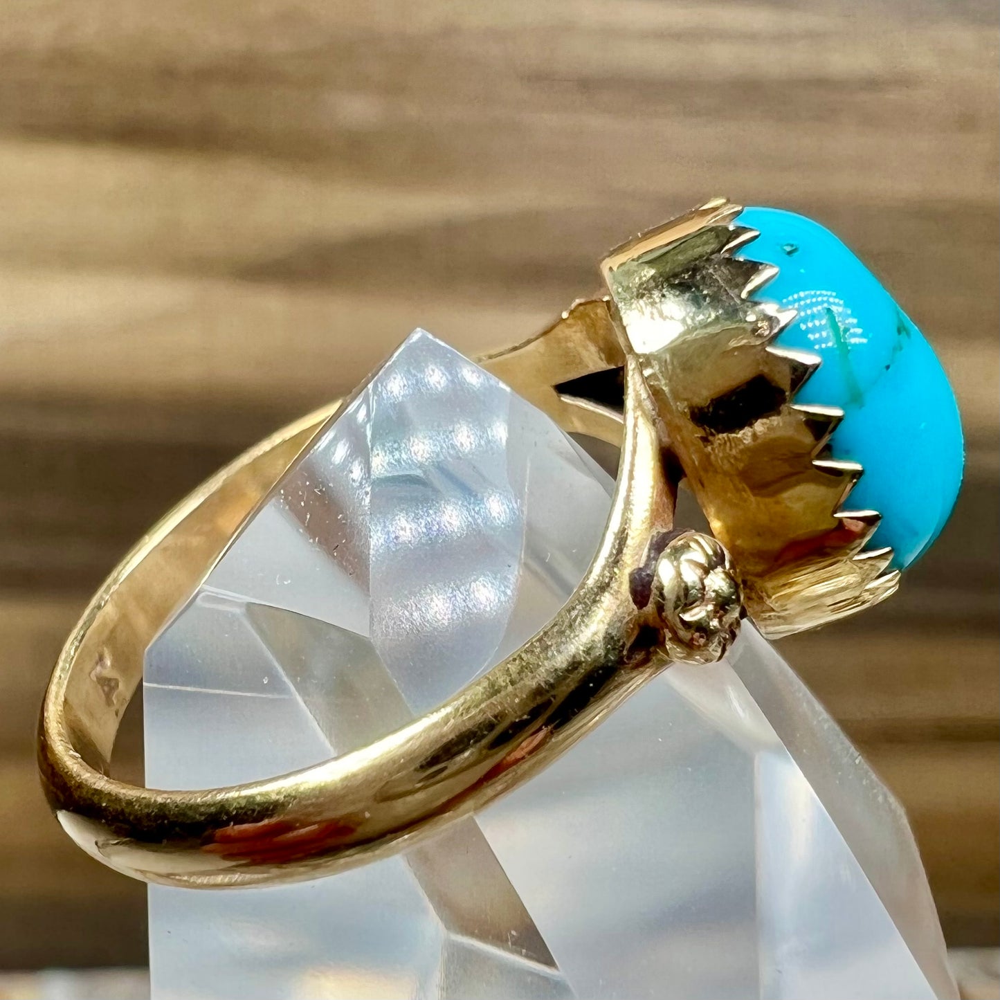 A ladies' yellow gold turquoise ring.  The turquoise is a round cabochon cut.