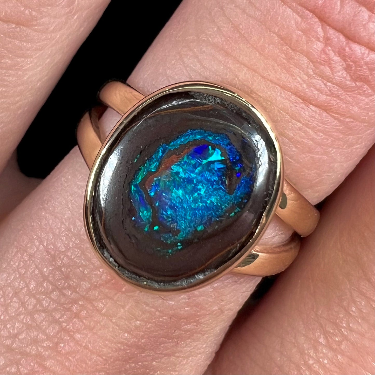 A natural Yowah Nut boulder opal split shank ring in 14kt yellow gold.